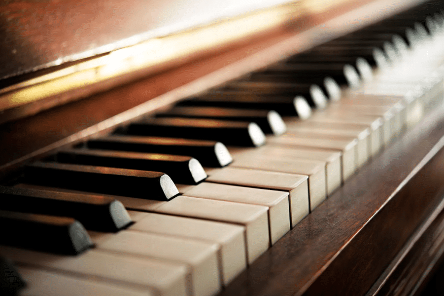 An old upright piano in a family home, waiting to be dealt with