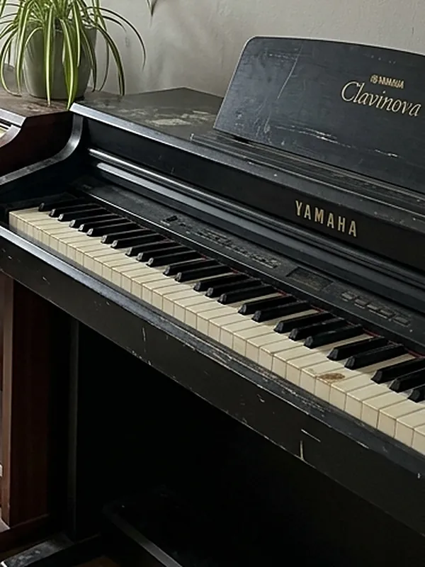 An old Yamaha digital piano with worn and discoloured keys