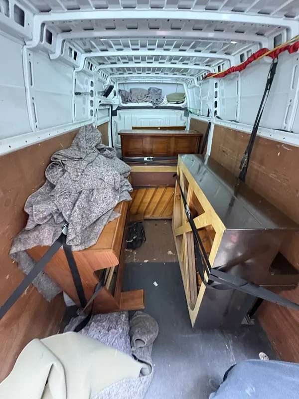 Several pianos loaded into a removal van for recycling