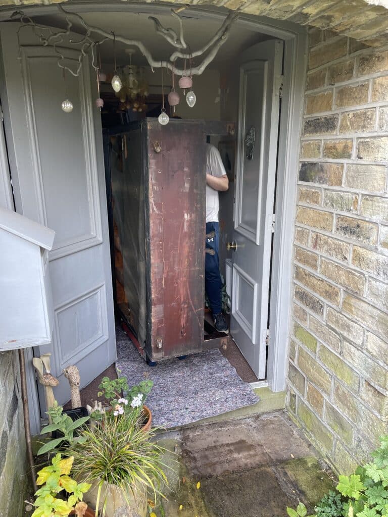 Collecting piano, moving out of doorway, out of the house. Piano Disposal.