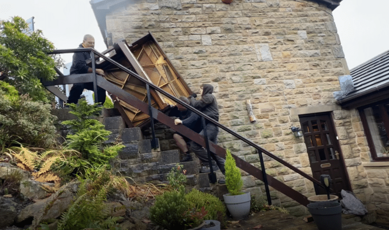 Moving Piano Up A Flight Of Steps For Disposal
